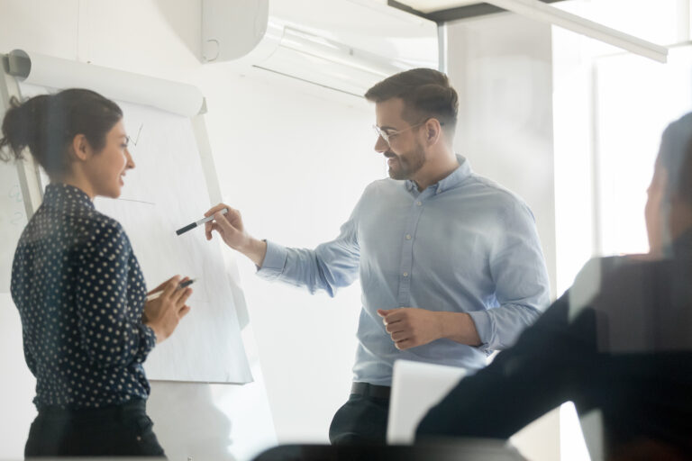 Diverse speakers make flip chart presentation in conference room Searching for a Payment Integration