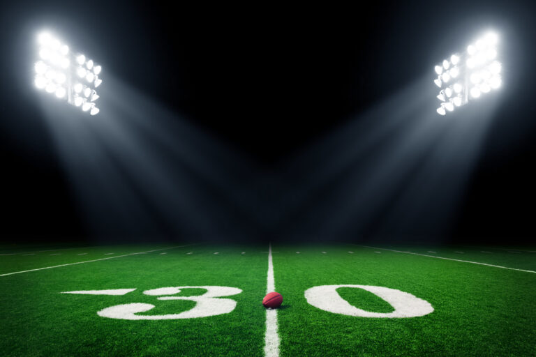 Football field illuminated by stadium lights Fantasy Sports Merchant Account